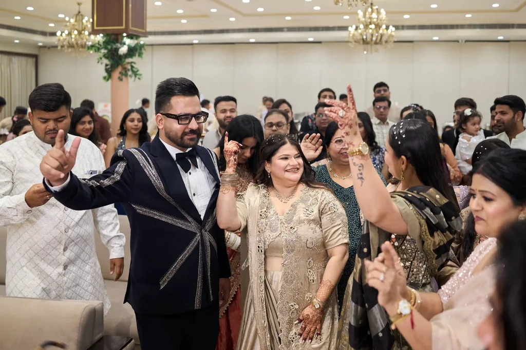 Couple dancing with family on the banquet floor at a Heritage Palace Varanasi engagement by The WeddingShoot